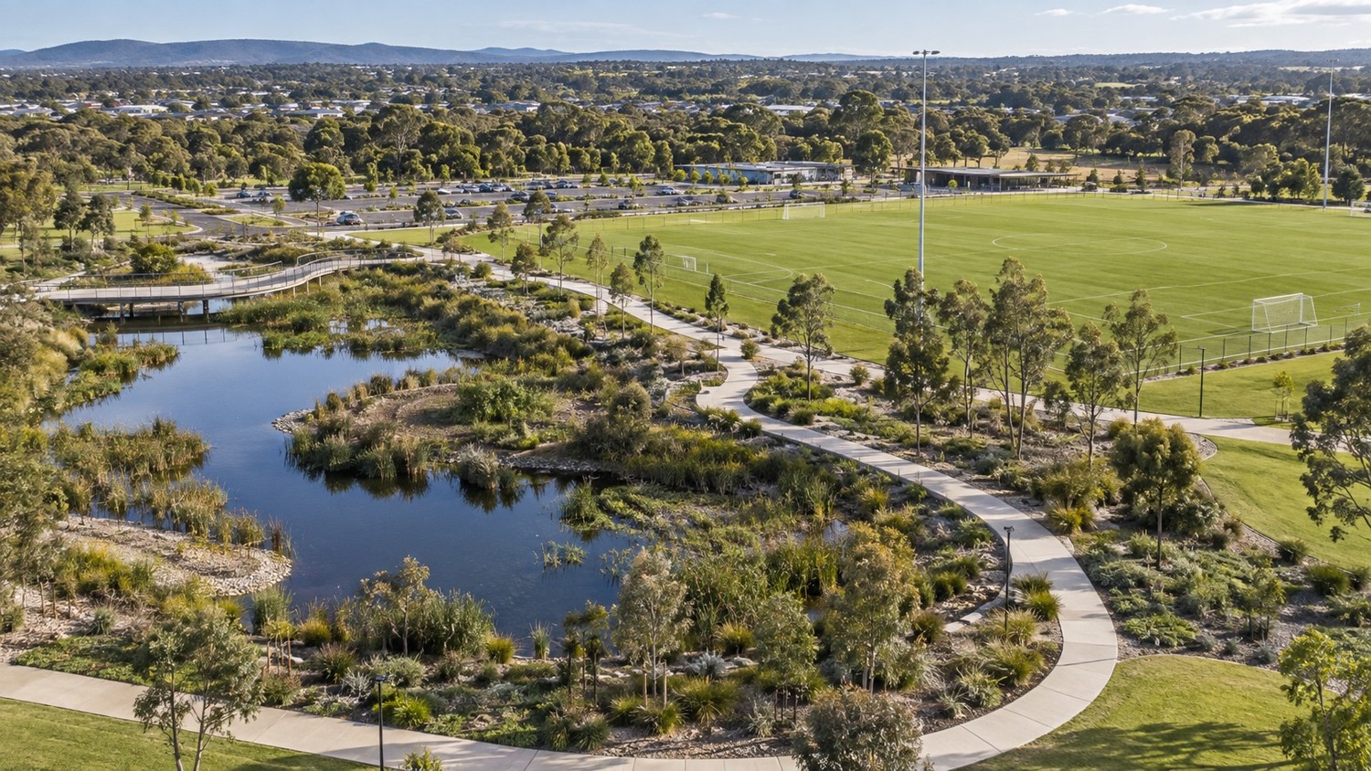 Illustrative landscaped precinct with paths, pond and recreation areas
