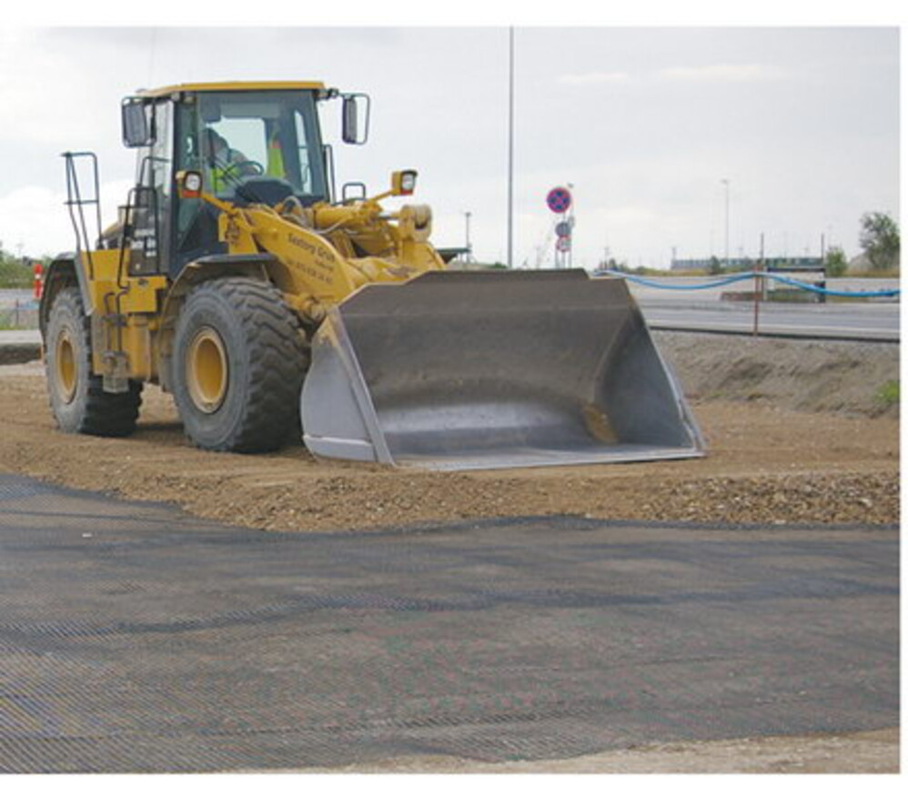 Loader placing aggregate over a geogrid working platform